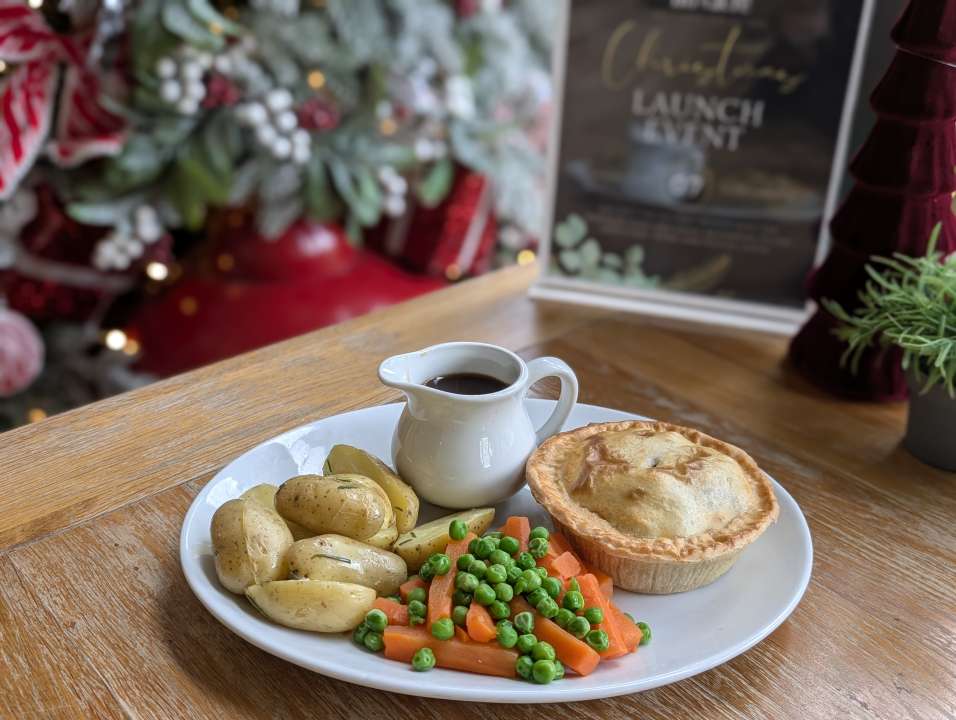 Pie of the day with buttered new potatoes, garden peas, carrots and rich gravy